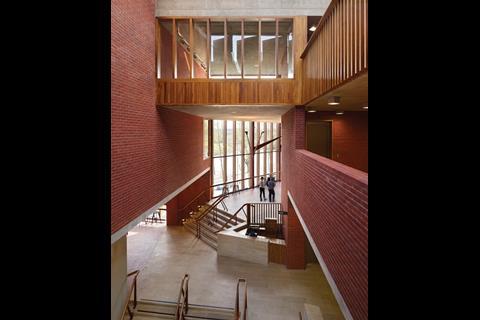 The lofty entrance atrium rises through a series of stepped foyers to the private timber world above.